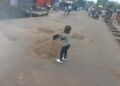 Two-Year-Old Boy Captured Helping Fill Potholes With Sand in Accra
