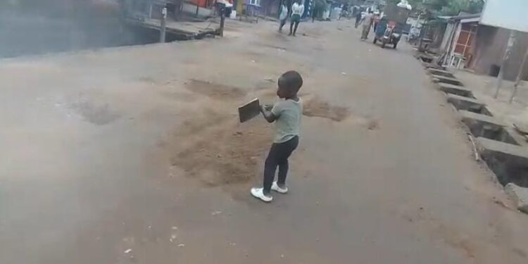 Two-Year-Old Boy Captured Helping Fill Potholes With Sand in Accra