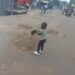 Two-Year-Old Boy Captured Helping Fill Potholes With Sand in Accra